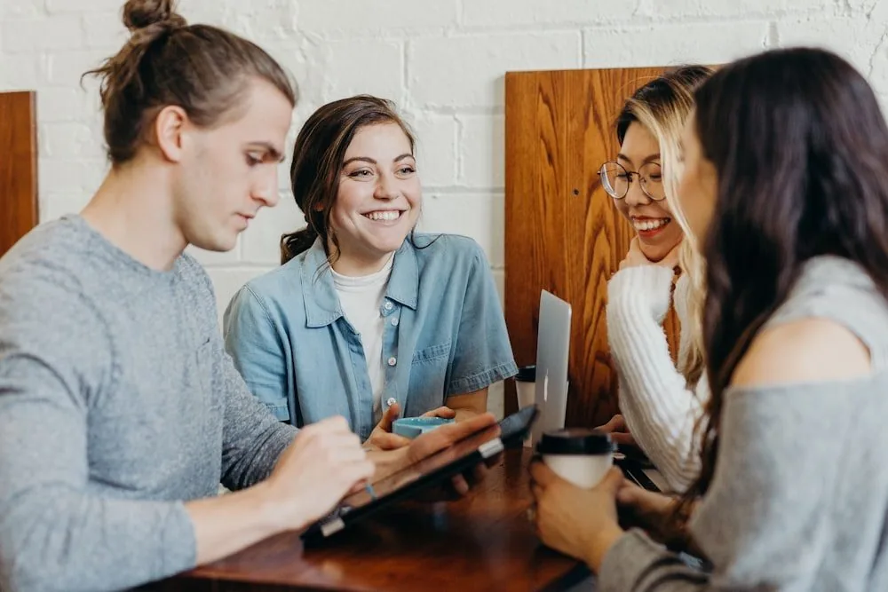 A small group in a workshop around a table
