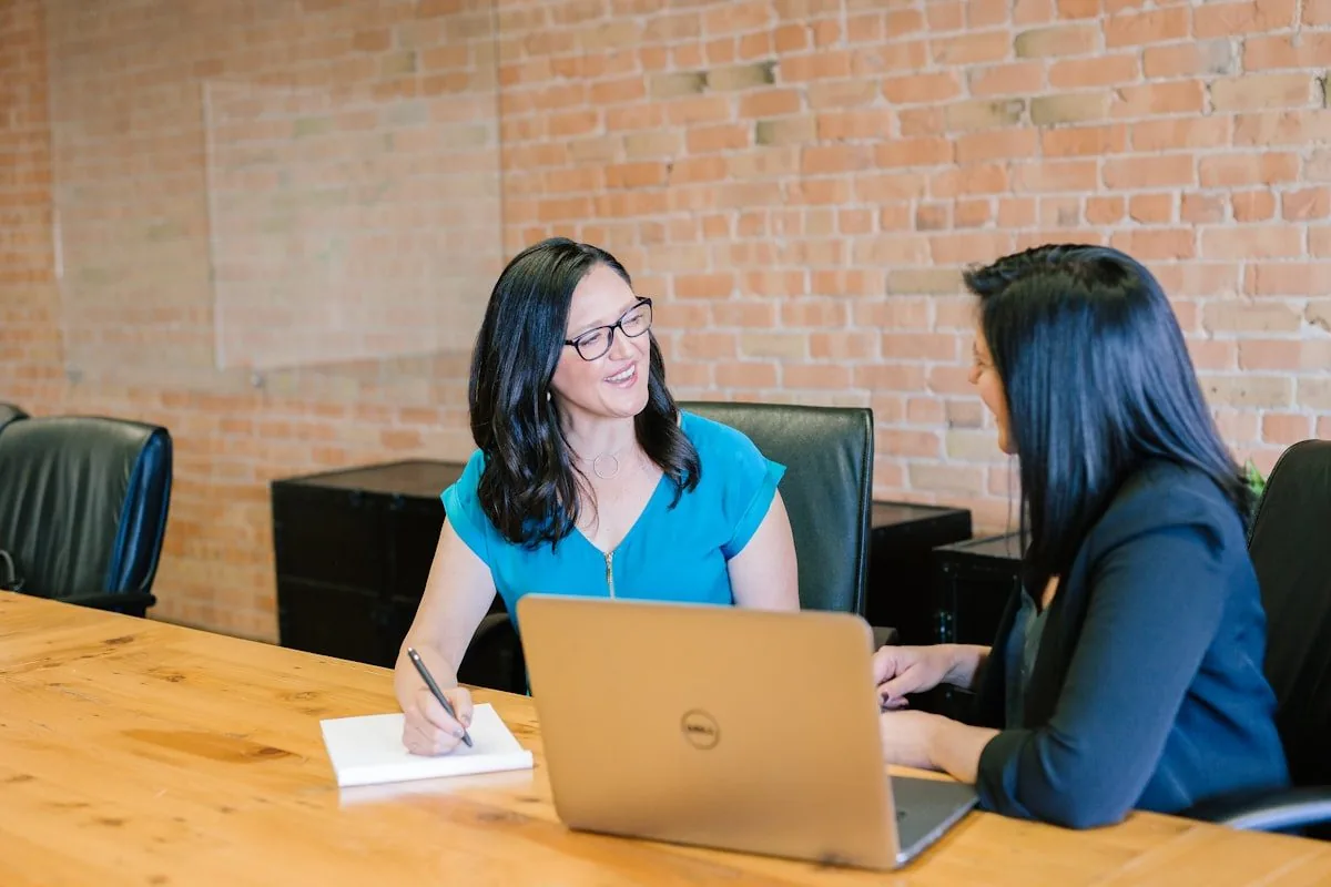 Two legal professionals working together at a laptop