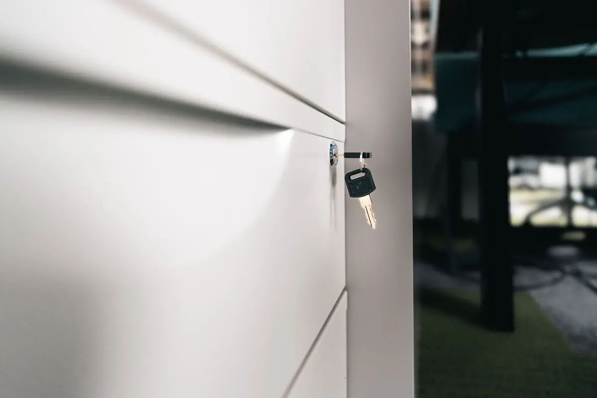 A key in the lock of an office drawer