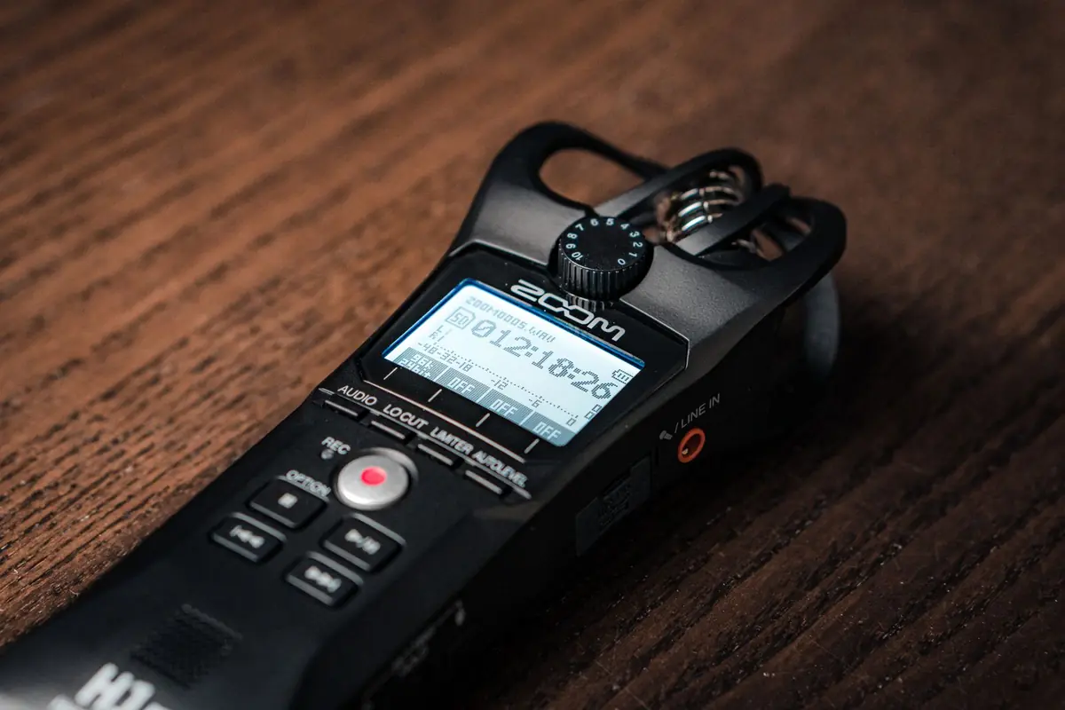 A digital voice recorder on a wooden table