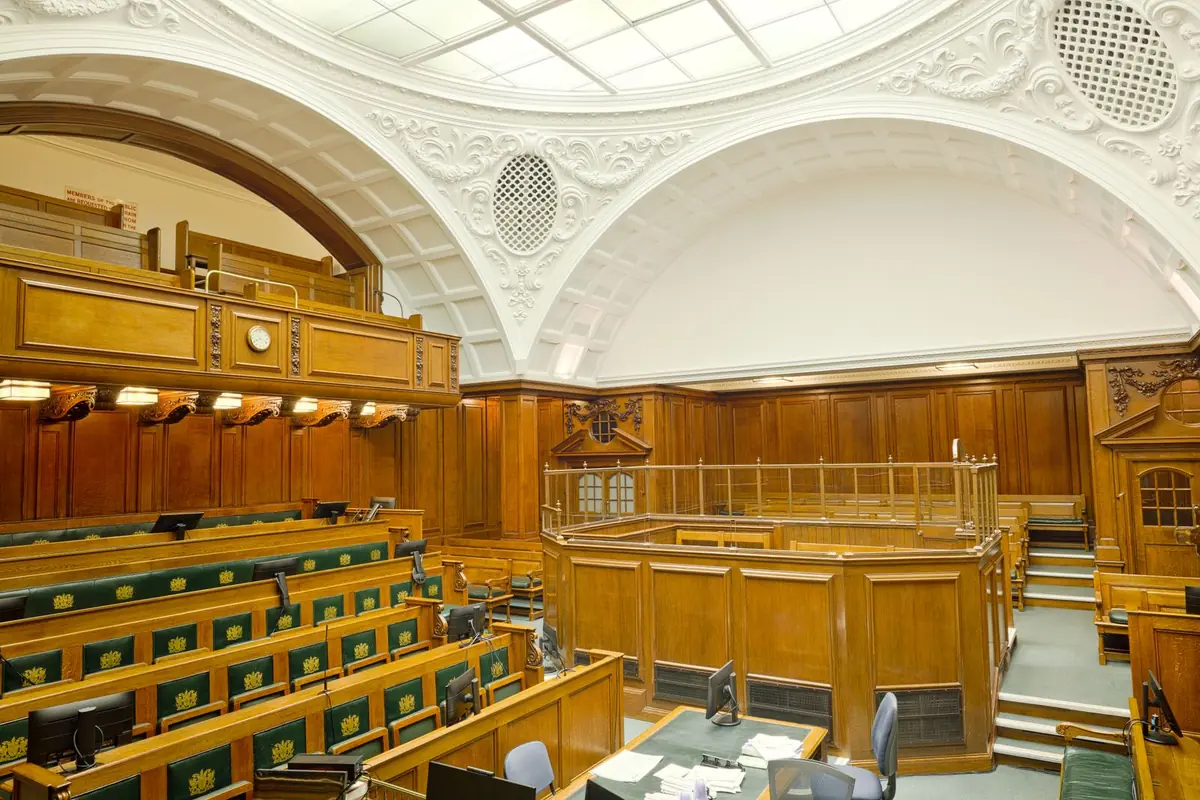 A historic London courtroom with wooden furnishings