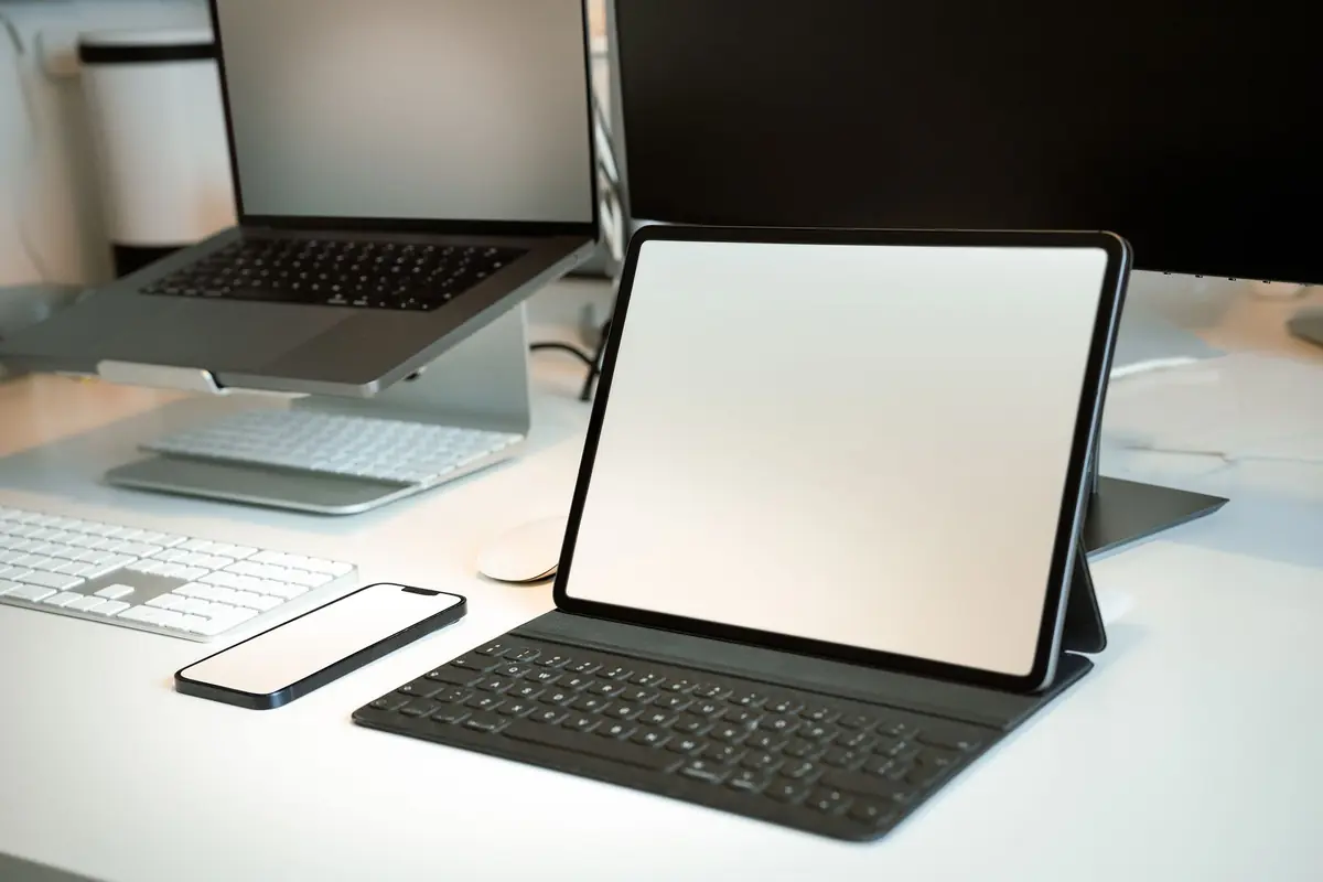 A workspace with laptop, tablet and smartphone together