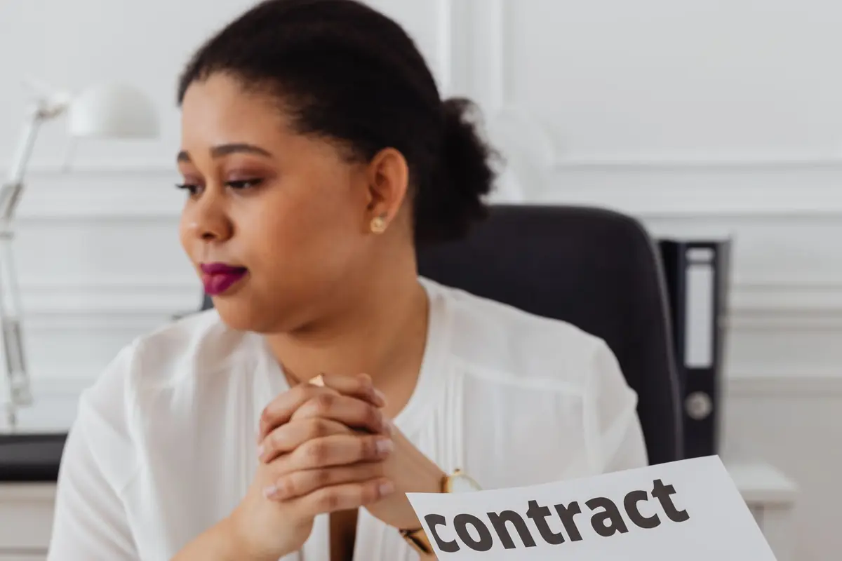 A professional reading a contract at her desk