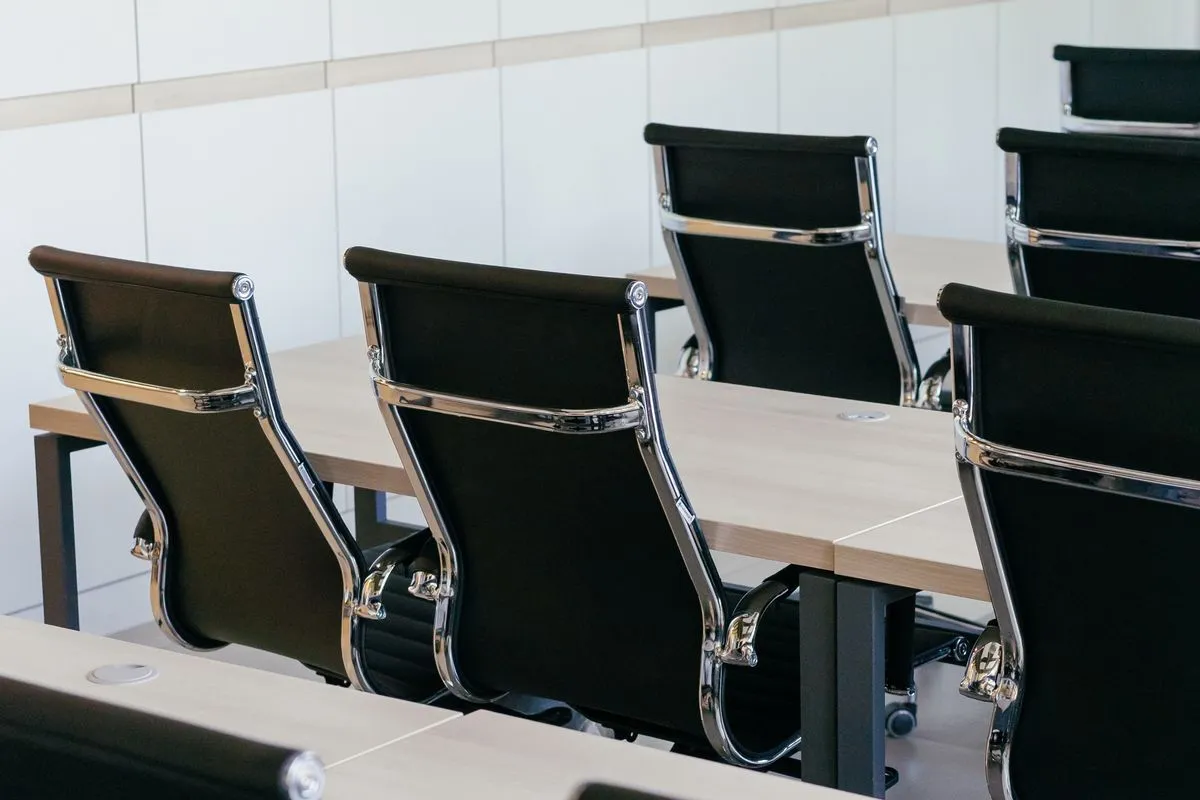 Empty chairs around a boardroom table