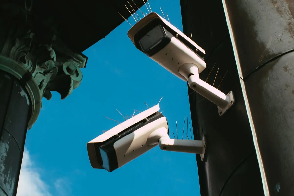 Two security cameras mounted on the corner of a building