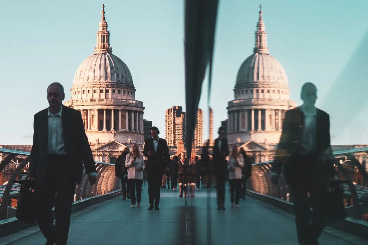 Commuters crossing the Millennium Bridge towards St Paul's Cathedral