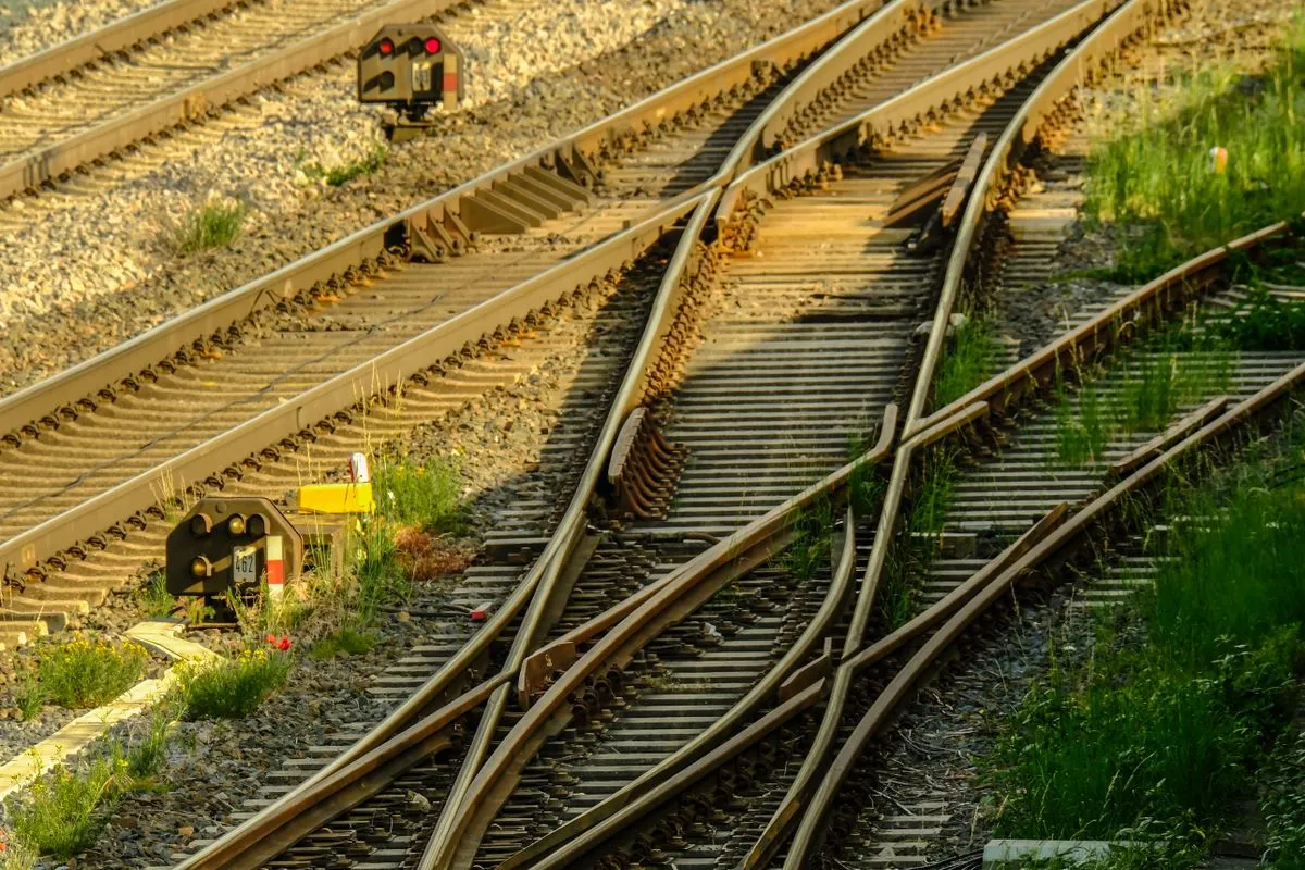 Railway points where two tracks diverge in evening light